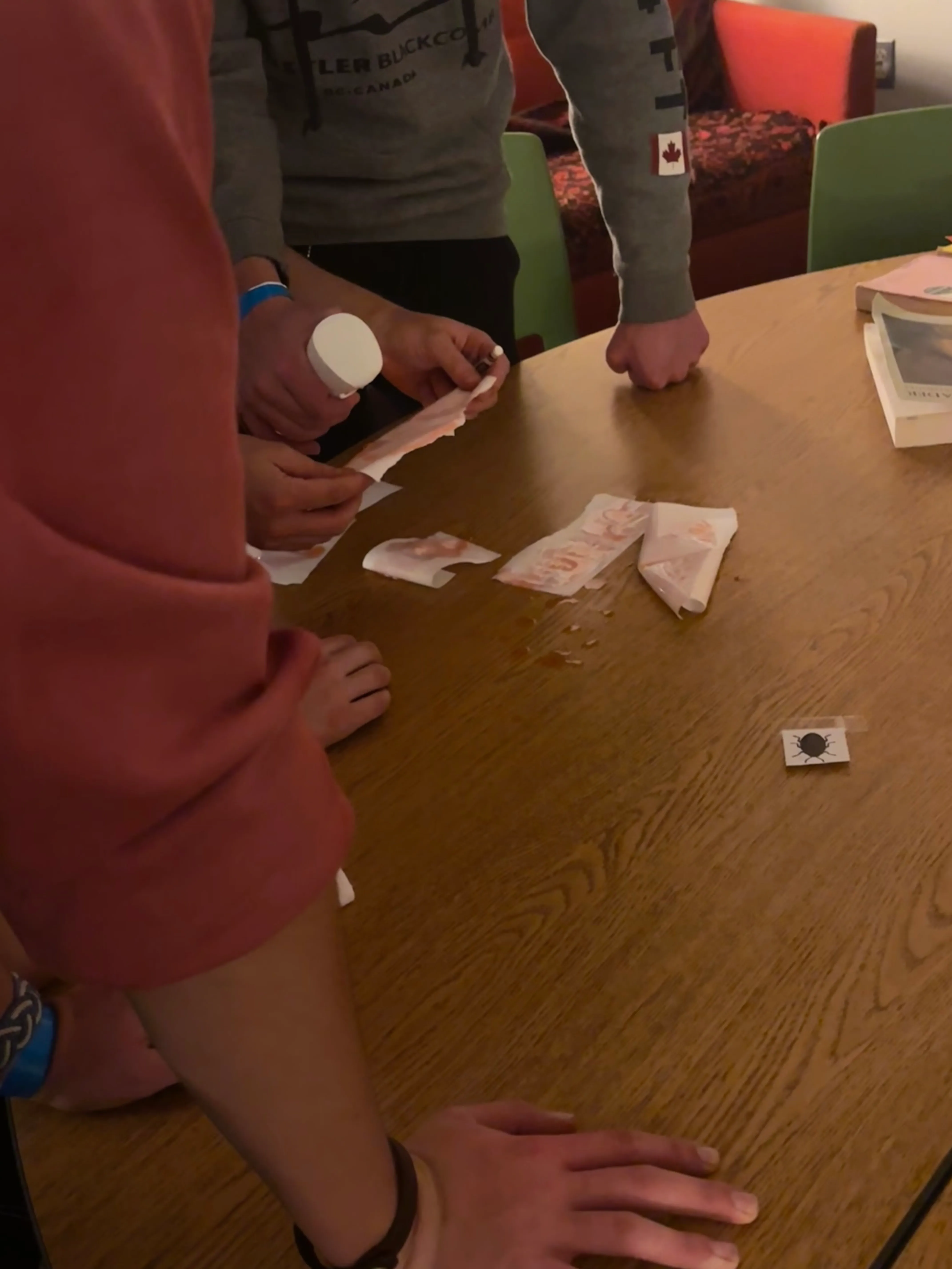 Escape room team “Magnificent Journey” reveals a secret message by spraying a Lobstah red “decoder” (dyed water) onto it. Nifty puzzle!