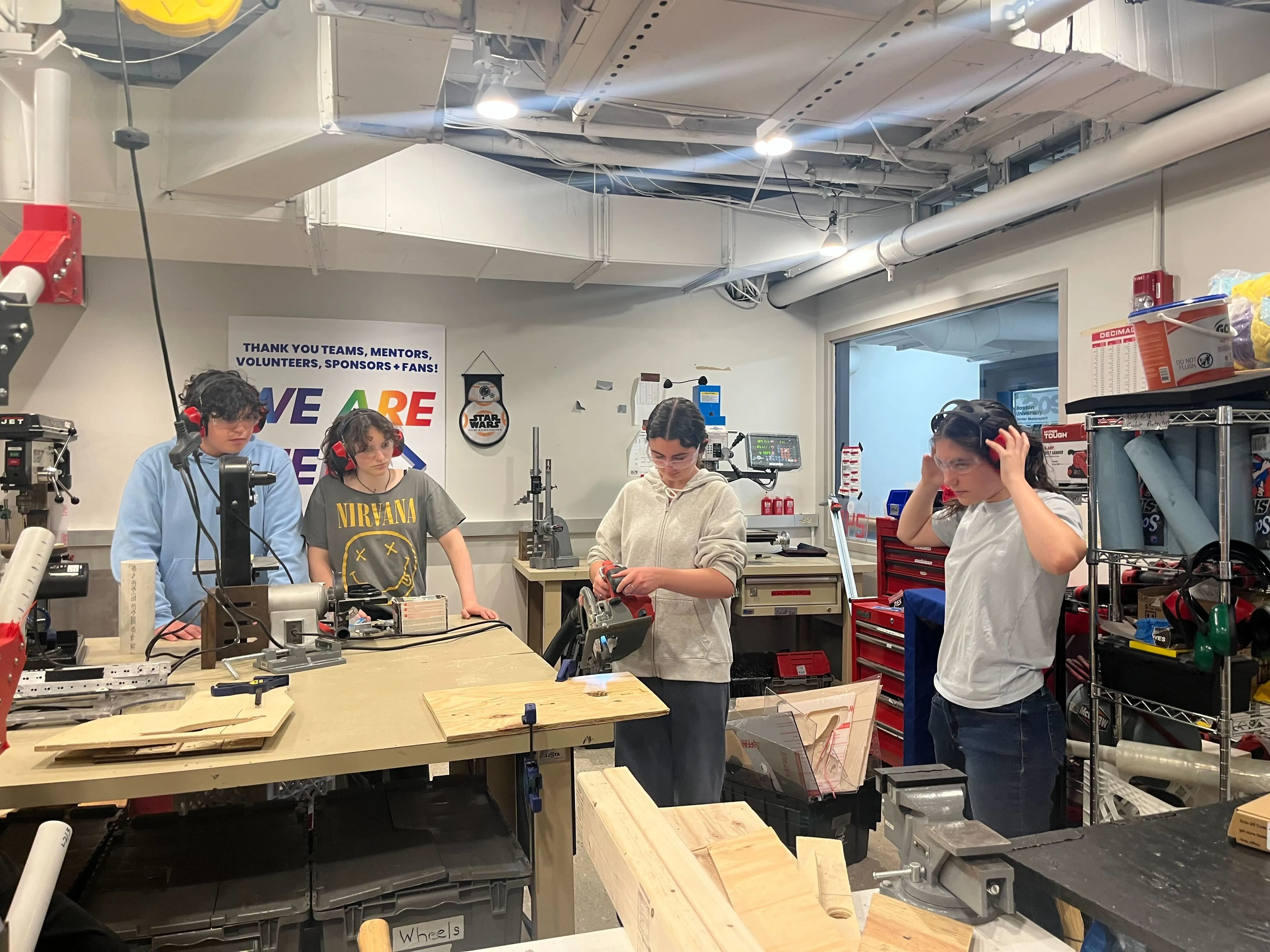 Lobstahs (left to right) Nate Rubenstein ‘28, Zoe Trogolo ‘26, Evie Caffrey-O’Reilly ‘28, learn how to use various saws in the lab, led by Fabrication lead Eliana Mirkis ‘28.