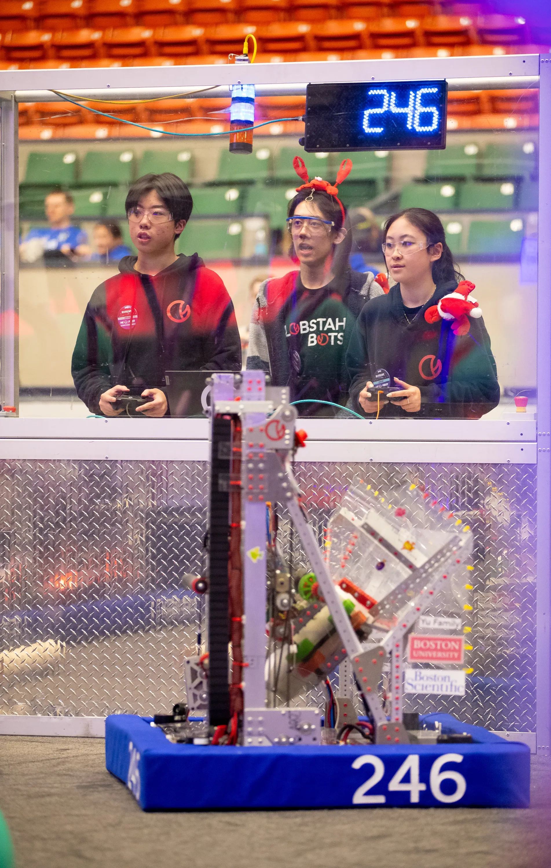 Drive team operates the robot during a DCMP match. From left to right: Teddy Shi (‘27) Maxwell Yu (‘25) and Sharon Xiong (‘27)
